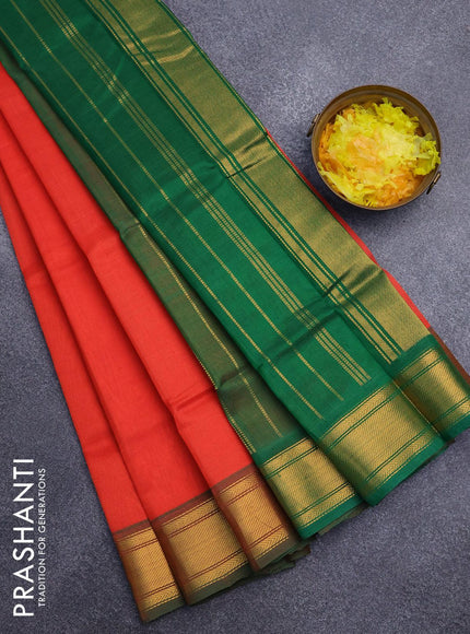 Silk cotton saree orange and green with plain body and zari woven border