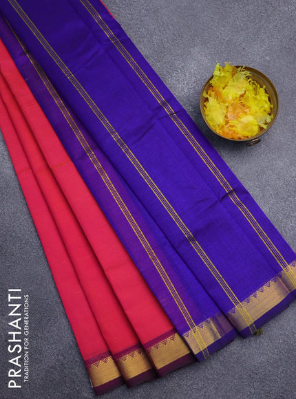 Silk cotton saree dual shade of pinkish orange and blue with plain body and small zari woven border