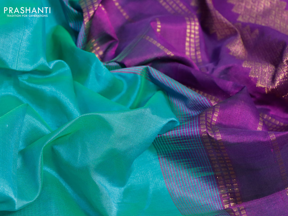 Silk cotton saree dual shade of teal blue and purple with plain body and rettapet zari woven border