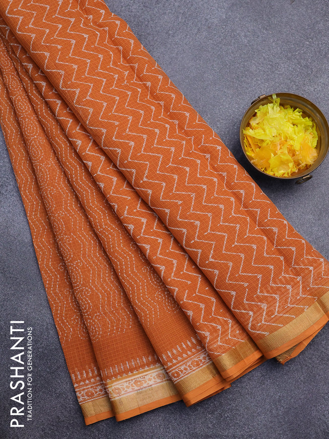 Kota saree orange with allover prints and zari woven border