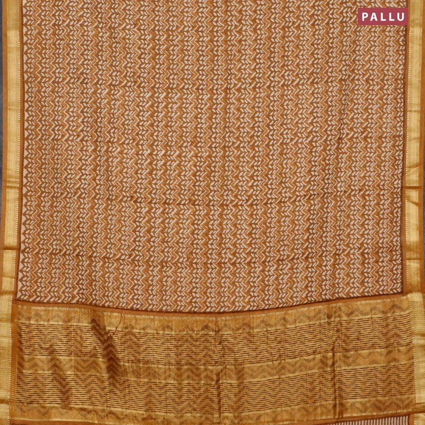 Malai silk saree dark mustard and mustard shade with allover prints and zari woven border