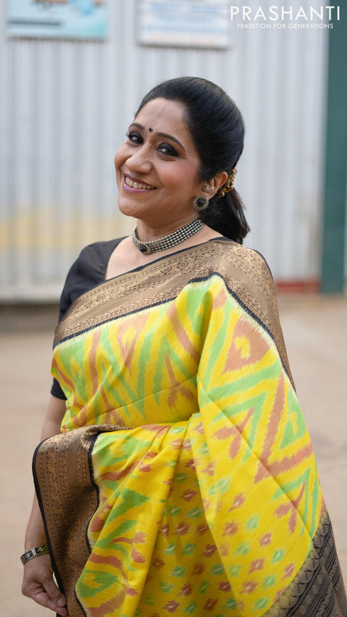 Ikat soft silk saree yellow and black with allover ikat weaves and zari woven border