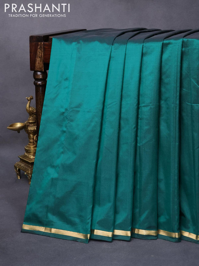 Kanjivaram silk saree green with plain body and small zari woven border