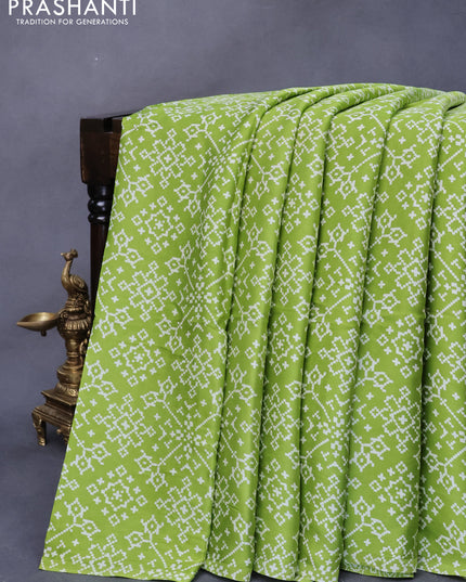 Modal silk saree fluorescent green with allover ikat prints and ajrakh printed pallu