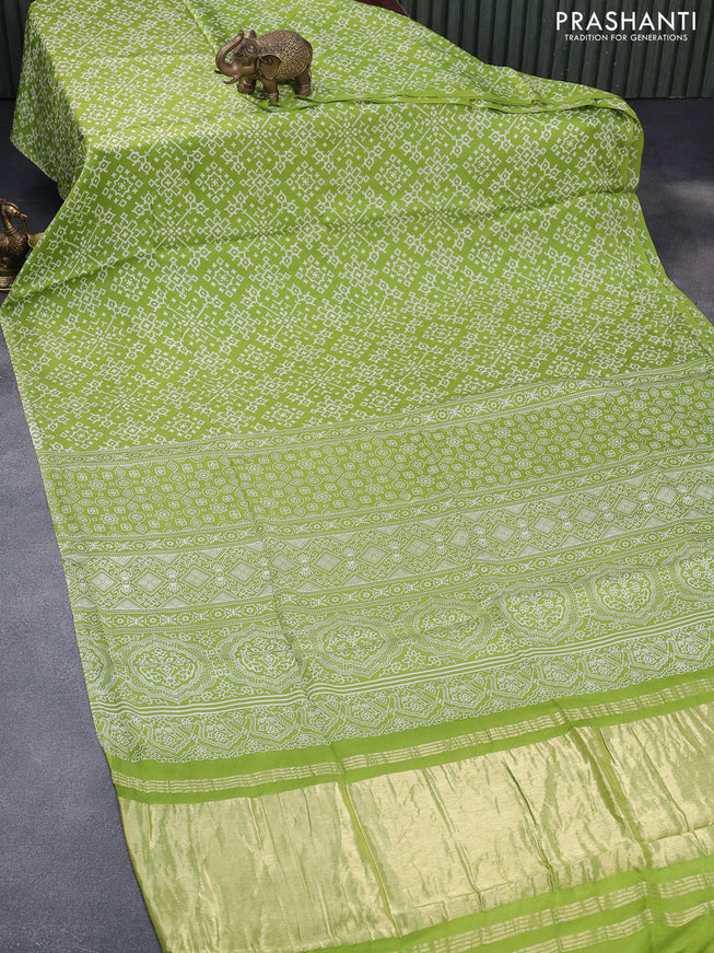 Modal silk saree fluorescent green with allover ikat prints and ajrakh printed pallu