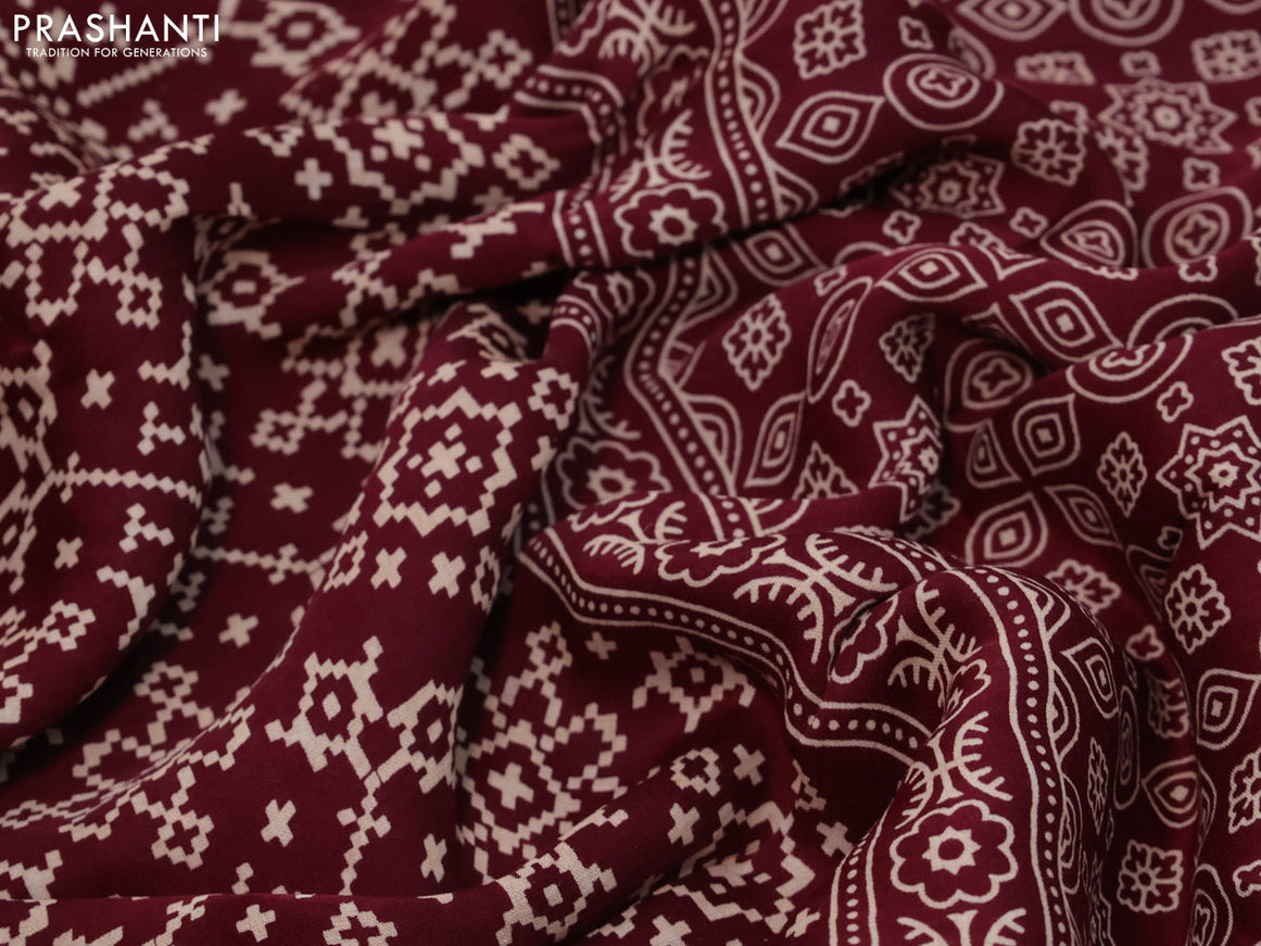 Modal silk saree deep maroon with allover ikat prints and ajrakh printed pallu