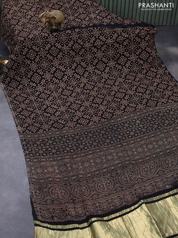 Modal silk saree black with allover ikat prints and ajrakh printed pallu