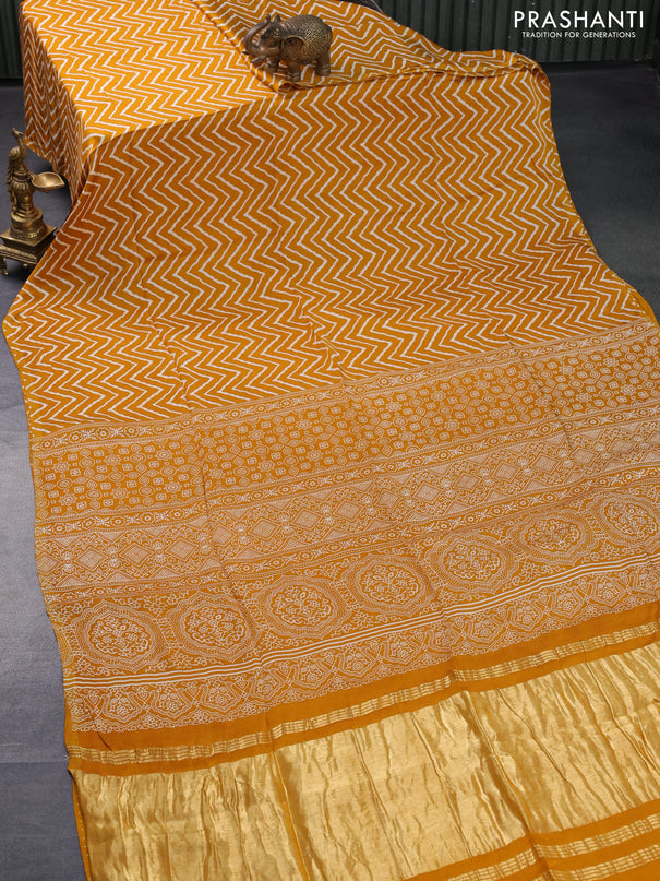 Modal silk saree mustard yellow with allover zig zag prints and ajrakh printed pallu