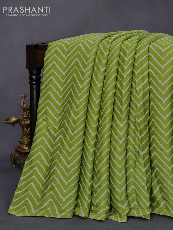 Modal silk saree fluorescent green with allover zig zag prints and ajrakh printed pallu