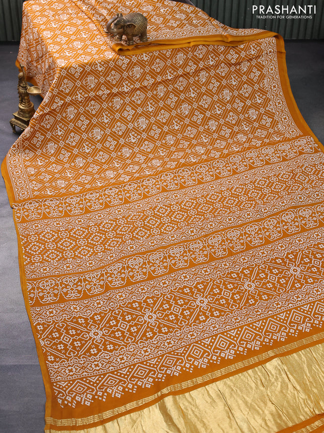 Modal silk saree mustard yellow with allover patola prints and zari woven pallu