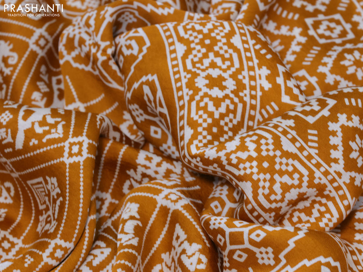 Modal silk saree mustard yellow with allover patola prints and zari woven pallu