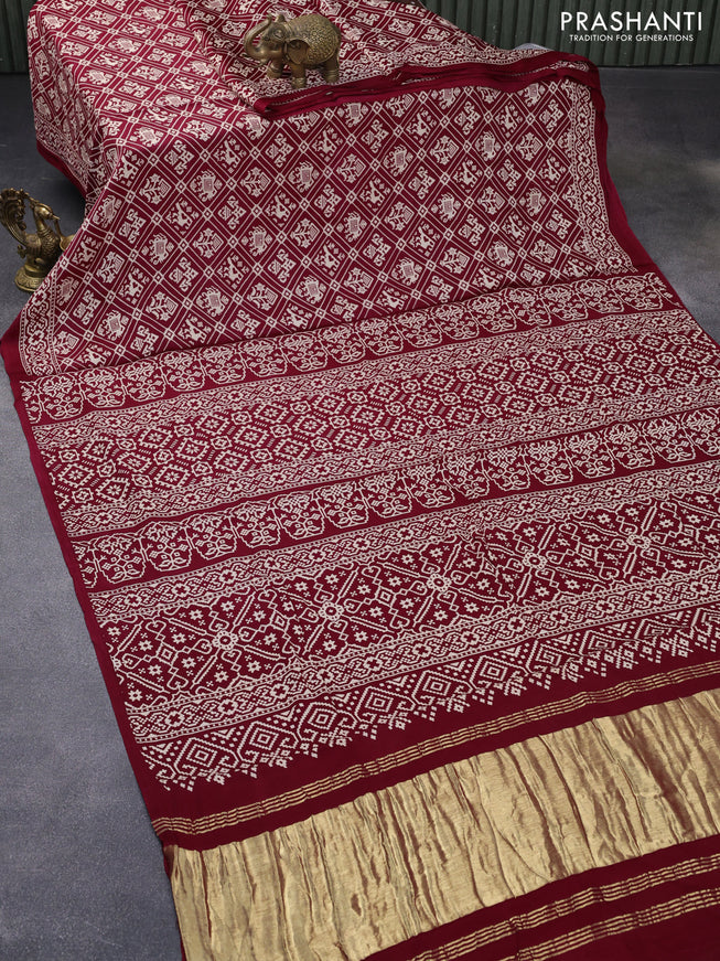 Modal silk saree maroon with allover patola prints and zari woven pallu