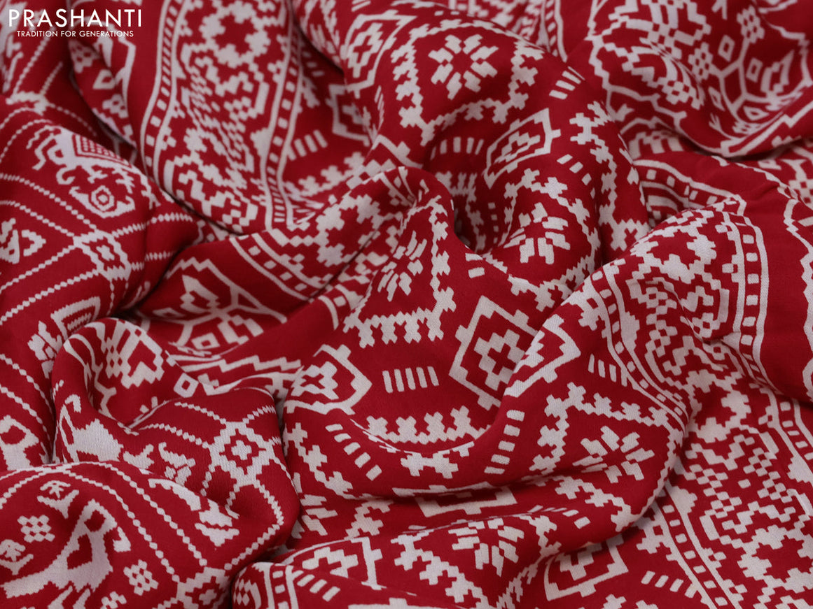 Modal silk saree red with allover patola prints and zari woven pallu