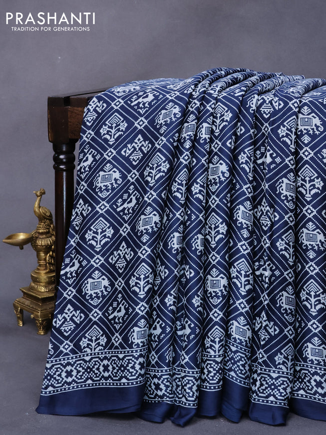 Modal silk saree peacock blue with allover patola prints and zari woven pallu