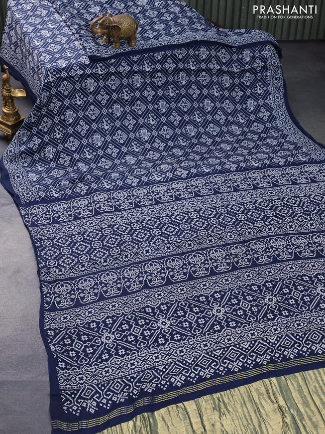 Modal silk saree peacock blue with allover patola prints and zari woven pallu