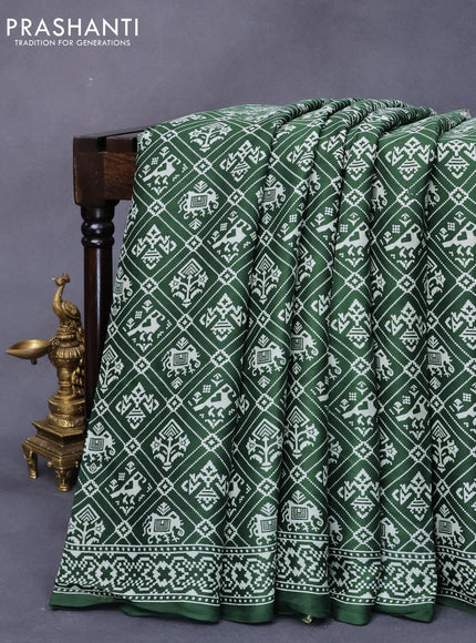 Modal silk saree green with allover patola prints and zari woven pallu