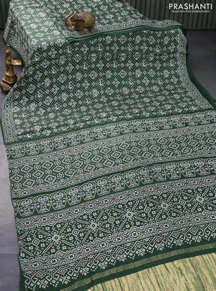 Modal silk saree green with allover patola prints and zari woven pallu