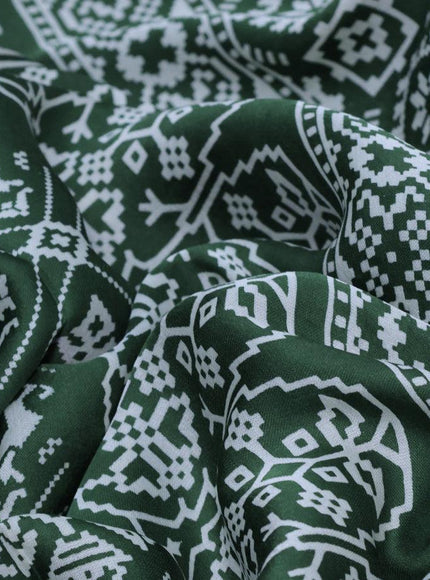 Modal silk saree green with allover patola prints and zari woven pallu