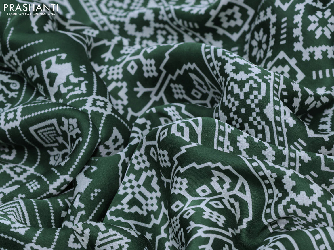 Modal silk saree green with allover patola prints and zari woven pallu