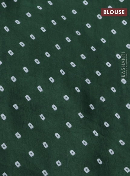 Modal silk saree green with allover patola prints and zari woven pallu