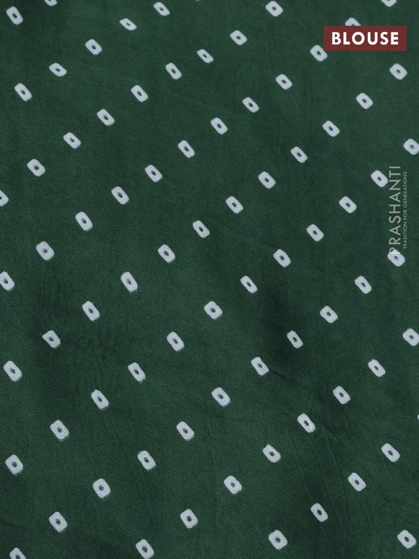 Modal silk saree green with allover patola prints and zari woven pallu