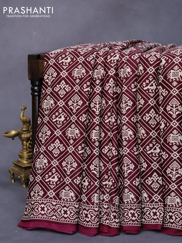 Modal silk saree wine shade with allover patola prints and zari woven pallu