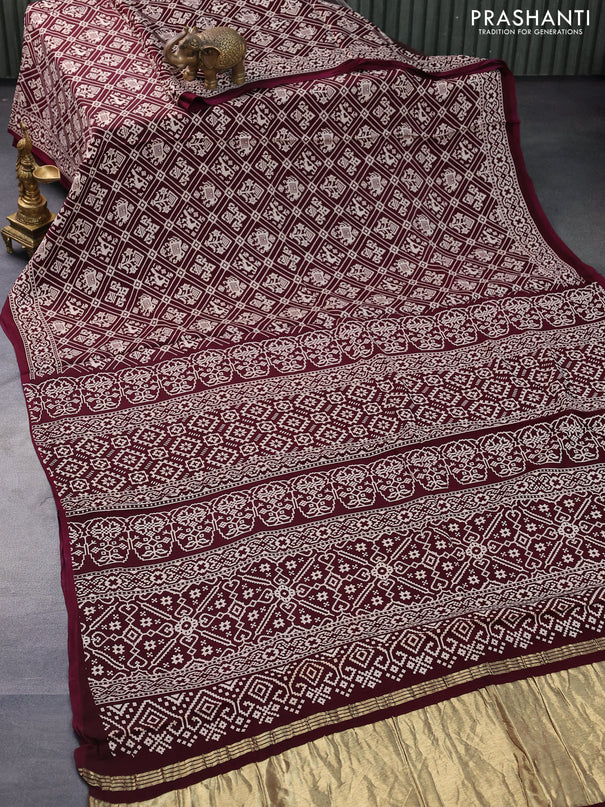 Modal silk saree wine shade with allover patola prints and zari woven pallu