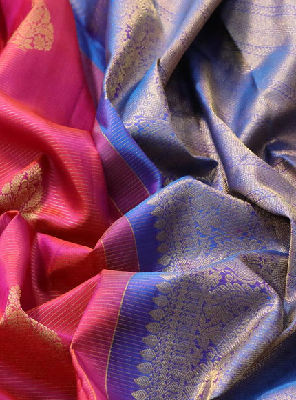 Pure kanjivaram silk saree dual shade of pinkish orange and dual shade of cs blue with allover zari weaves & buttas and zari woven annam border