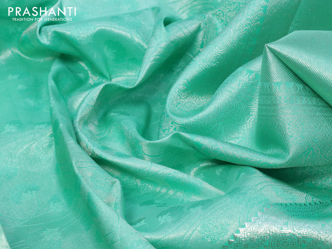 Pure kanjivaram silk saree teal green with allover silver zari woven brocade weaves and silver zari woven border