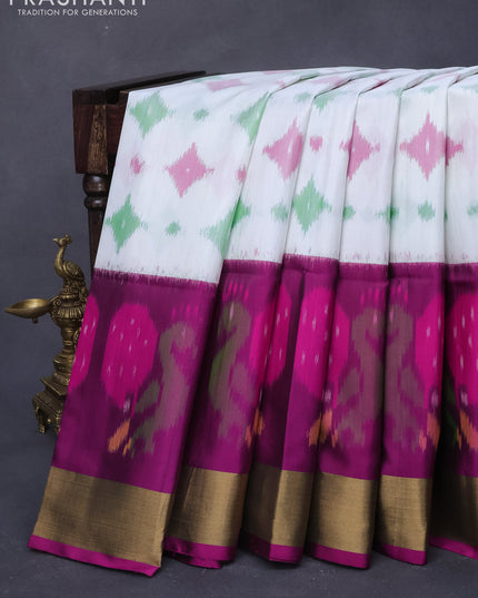 Ikat soft silk saree off white and magenta pink with allover ikat butta weaves and long ikat woven zari border