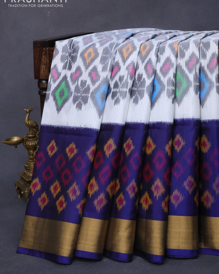 Ikat soft silk saree off white and dark blue with allover ikat weaves and long ikat woven zari border