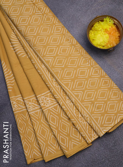 Jaipur cotton saree mustard shade with leaf butta prints and printed border