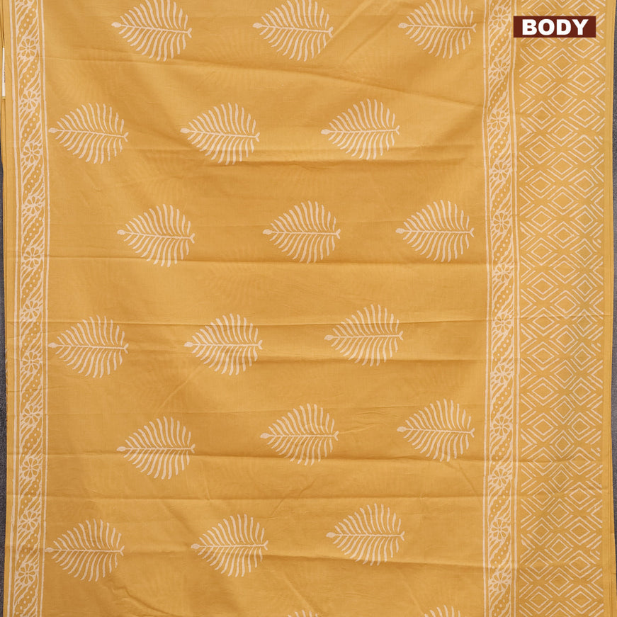 Jaipur cotton saree mustard shade with leaf butta prints and printed border