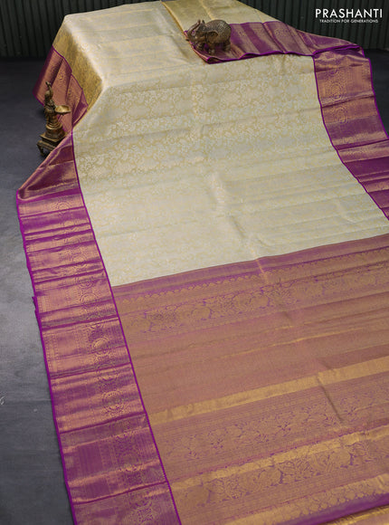 Pure kanjivaram tissue silk saree cream and purple with allover silver zari woven brocade weaves and long rich annam zari woven border