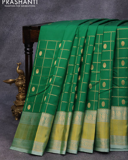 Pure kanjivaram silk saree green and green shade with zari woven buttas and rettapet zari woven border