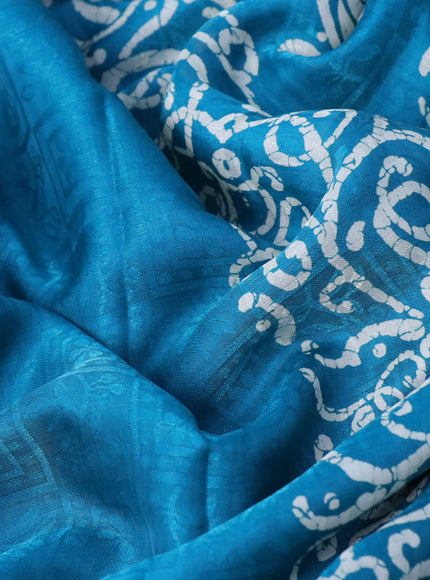 Semi crepe saree teal blue with allover self emboss and batik printed border