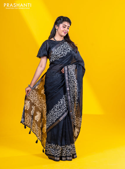 Semi crepe saree black with allover self emboss and batik printed border