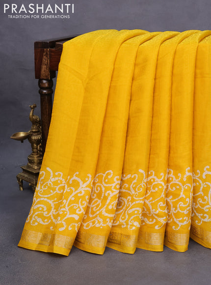 Semi crepe saree yellow with allover self emboss and batik printed border