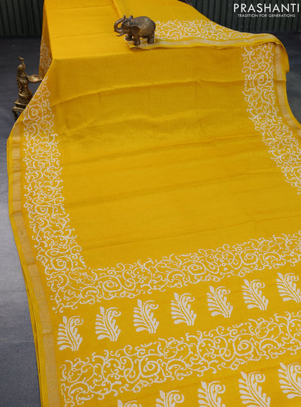 Semi crepe saree yellow with allover self emboss and batik printed border