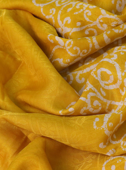 Semi crepe saree yellow with allover self emboss and batik printed border