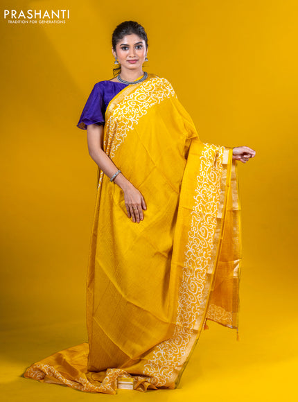 Semi crepe saree yellow with allover self emboss and batik printed border