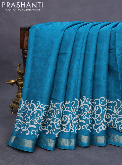 Semi crepe saree teal blue with allover self emboss and batik printed border