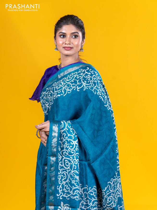 Semi crepe saree teal blue with allover self emboss and batik printed border