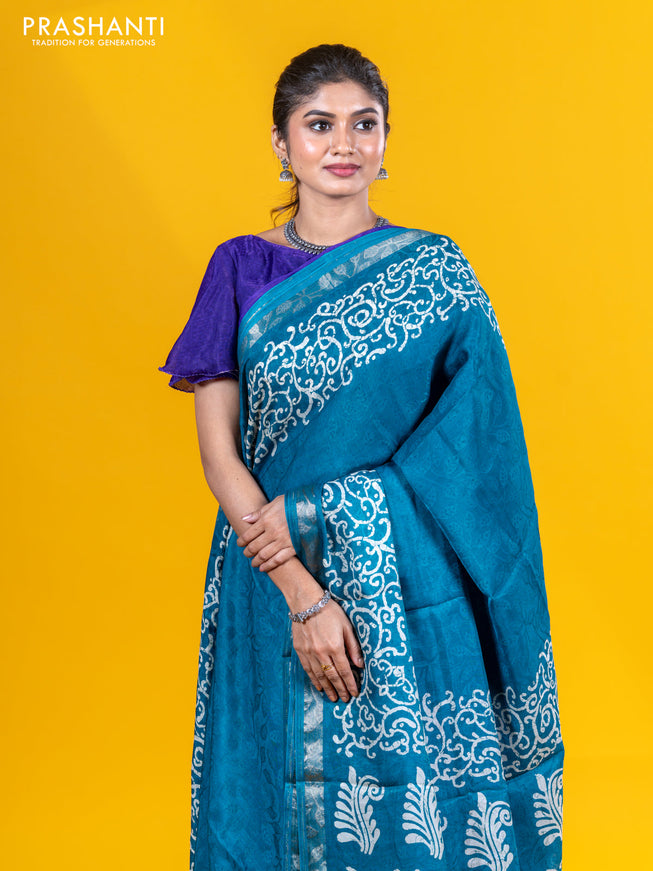 Semi crepe saree teal blue with allover self emboss and batik printed border