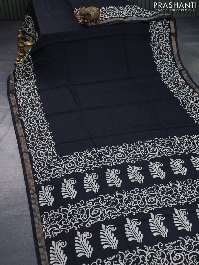 Semi crepe saree black with allover self emboss and batik printed border