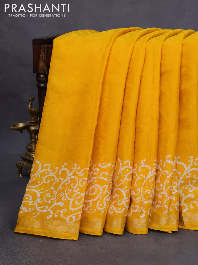 Semi crepe saree mango yellow with allover self emboss and batik printed border