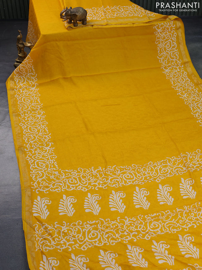 Semi crepe saree mango yellow with allover self emboss and batik printed border