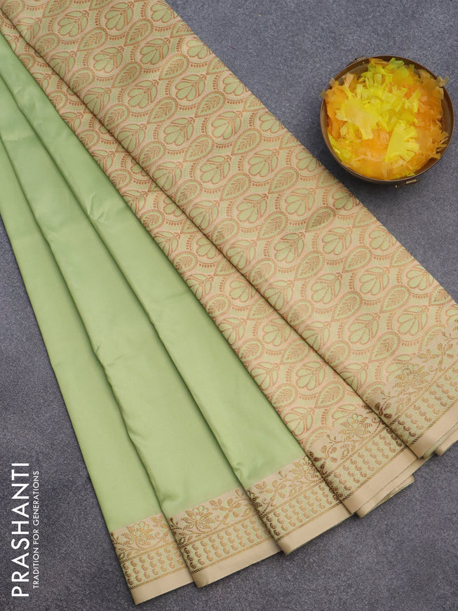 Semi banarasi katan saree pista green and cream with plain body and zari woven border