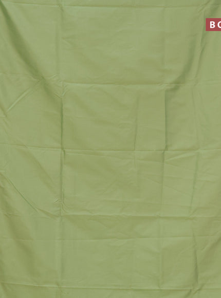 Semi banarasi katan saree pista green and cream with plain body and zari woven border