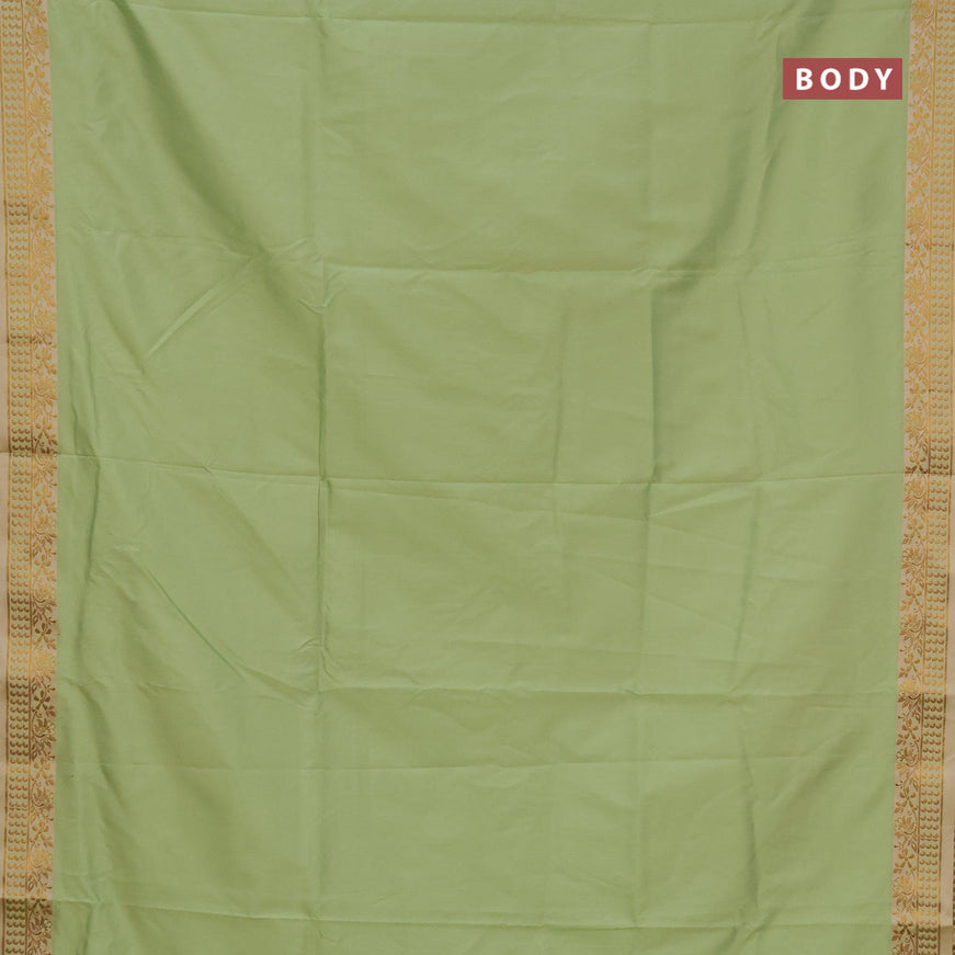 Semi banarasi katan saree pista green and cream with plain body and zari woven border